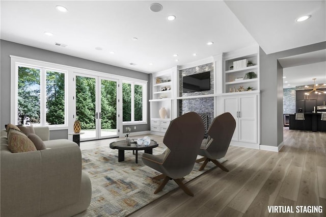 2616 W 112th St, Leawood, KS 66211 - living room featuring plenty of natural light, light wood finished floors, recessed lighting, and built in shelves