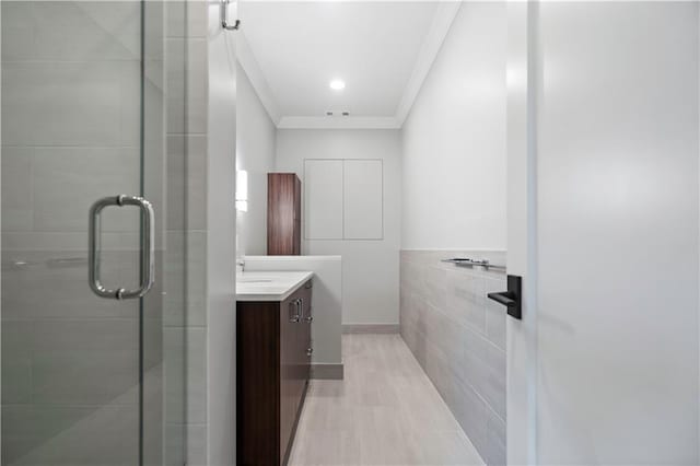 2616 W 112th St, Leawood, KS 66211 - full bathroom with ornamental molding, vanity, a stall shower, and tile walls