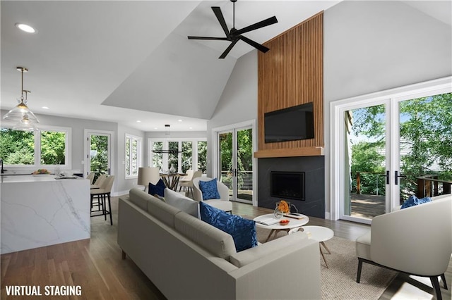 2616 W 112th St, Leawood, KS 66211 - living room with high vaulted ceiling, a large fireplace, ceiling fan, wood finished floors, and recessed lighting