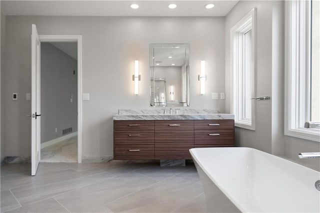 2616 W 112th St, Leawood, KS 66211 - full bathroom featuring vanity, a freestanding tub, recessed lighting, and tile patterned flooring