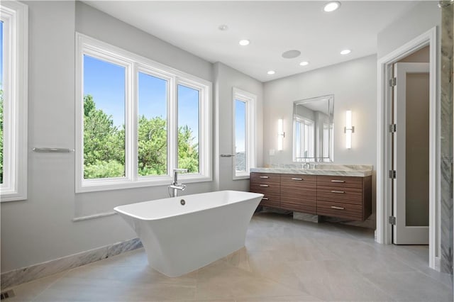 2616 W 112th St, Leawood, KS 66211 - full bathroom with vanity, a soaking tub, recessed lighting, and tile patterned floors
