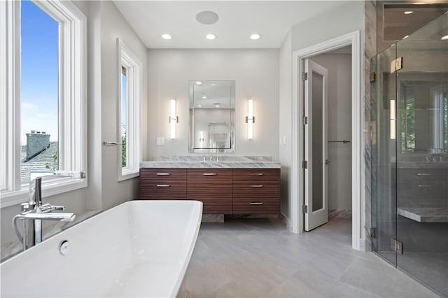 2616 W 112th St, Leawood, KS 66211 - full bathroom with vanity, a shower stall, a freestanding tub, tile patterned flooring, and recessed lighting