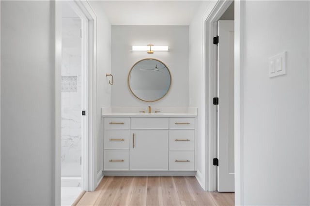 2616 W 112th St, Leawood, KS 66211 - bathroom with vanity, a marble finish shower, and wood finished floors