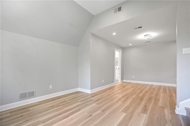 2616 W 112th St, Leawood, KS 66211 - empty room featuring light wood finished floors, lofted ceiling, and recessed lighting