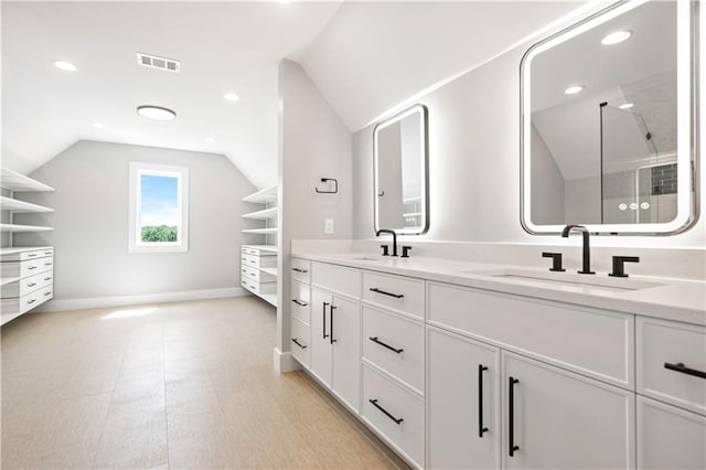 2616 W 112th St, Leawood, KS 66211 - full bathroom with lofted ceiling, double vanity, a shower with door, and recessed lighting