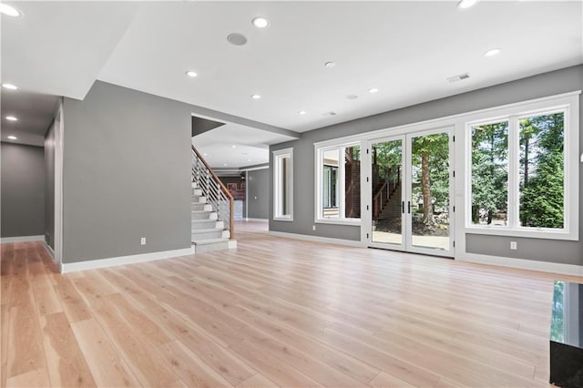 2616 W 112th St, Leawood, KS 66211 - unfurnished living room with stairs, light wood finished floors, and recessed lighting