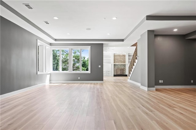 2616 W 112th St, Leawood, KS 66211 - unfurnished living room featuring stairway, light wood-type flooring, and recessed lighting