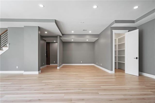 2616 W 112th St, Leawood, KS 66211 - spare room featuring light wood finished floors, recessed lighting, and stairs