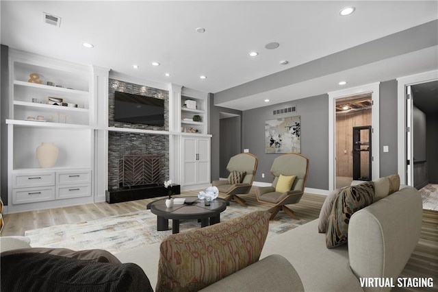 2616 W 112th St, Leawood, KS 66211 - living area with light wood-style floors, recessed lighting, built in features, and a fireplace