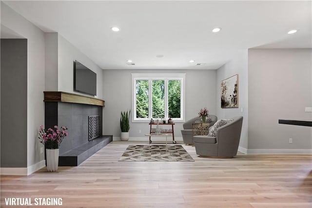 2616 W 112th St, Leawood, KS 66211 - living area with a fireplace, light wood-style flooring, and recessed lighting