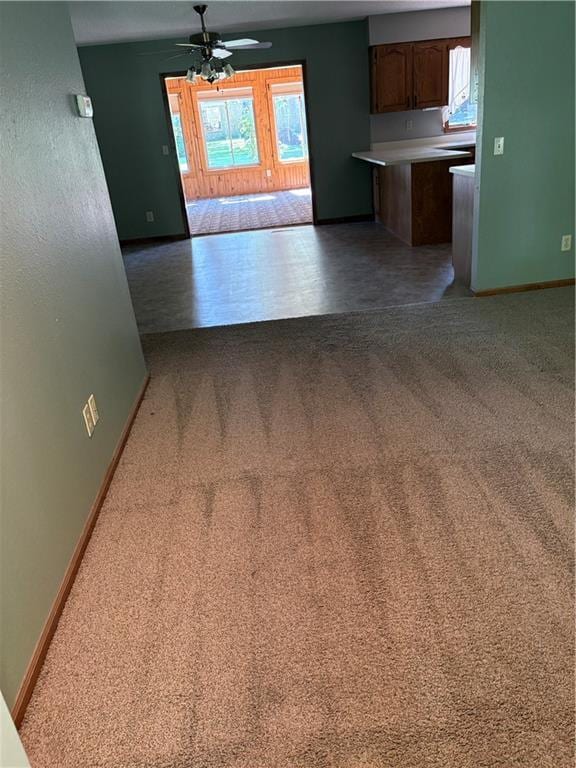 105 N Hayes St, Garnett, KS 66032 - unfurnished living room featuring a ceiling fan and light colored carpet
