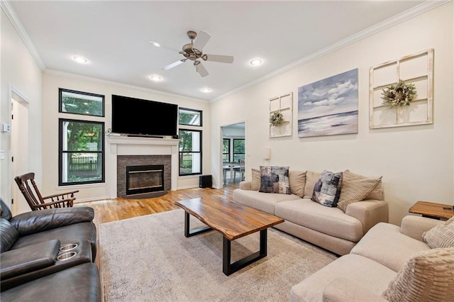 1311 SE Eastridge Cir, Blue Springs, MO 64014 - living area featuring ornamental molding, wood finished floors, ceiling fan, a glass covered fireplace, and recessed lighting