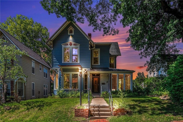 118 Spruce St, Leavenworth, KS 66048 - victorian home with a lawn and a chimney