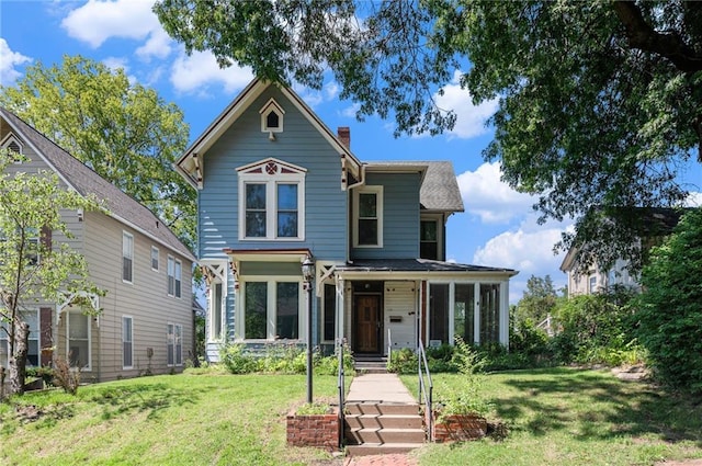 118 Spruce St, Leavenworth, KS 66048 - victorian-style house with a front yard and a chimney