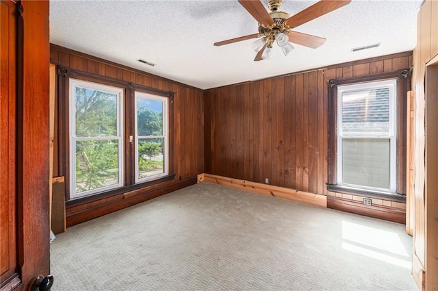 118 Spruce St, Leavenworth, KS 66048 - unfurnished room with wood walls, carpet floors, a ceiling fan, and a textured ceiling