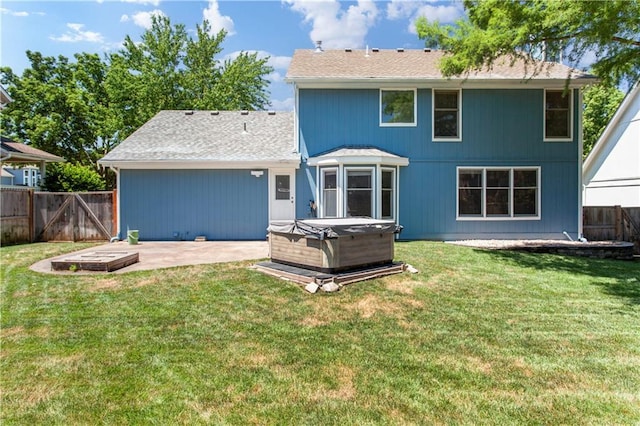 1321 SW Crossing Dr, Lees Summit, MO 64081 - back of house featuring a hot tub, a patio area, a fenced backyard, and a shingled roof
