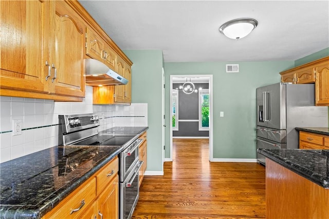 1321 SW Crossing Dr, Lees Summit, MO 64081 - kitchen with stainless steel appliances, under cabinet range hood, dark wood-type flooring, and brown cabinets