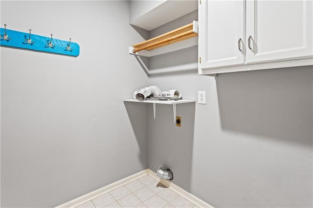 1321 SW Crossing Dr, Lees Summit, MO 64081 - laundry area featuring electric dryer hookup, tile patterned flooring, and cabinet space