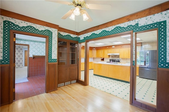 14610 State Route Dd Hwy, Savannah, MO 64485 - dining space featuring wallpapered walls, a wainscoted wall, light wood-style floors, and a ceiling fan