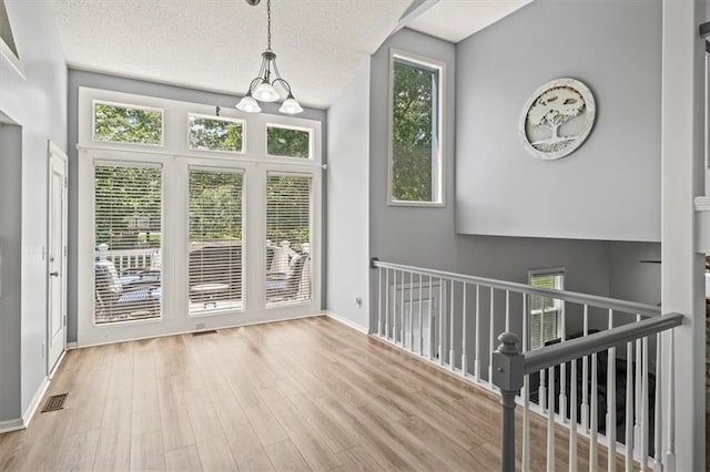 17277 W 157th St, Olathe, KS 66062 - foyer featuring wood finished floors and a textured ceiling