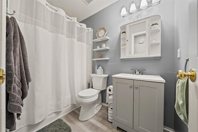 17277 W 157th St, Olathe, KS 66062 - bathroom with wood finished floors, vanity, a textured ceiling, and shower / tub combo