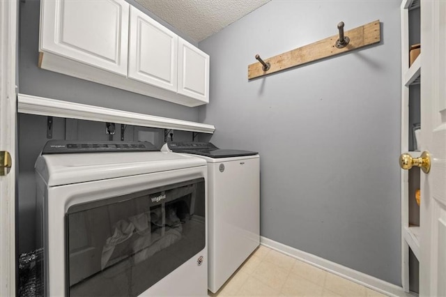 17277 W 157th St, Olathe, KS 66062 - laundry area with cabinet space, separate washer and dryer, and a textured ceiling