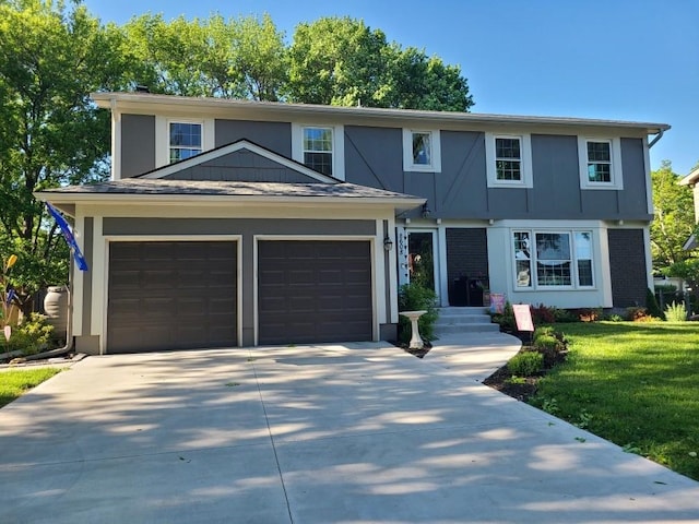 8608 W 90th Ter, Overland Park, KS 66212 - view of front of home with driveway, a front lawn, a garage, and stucco siding