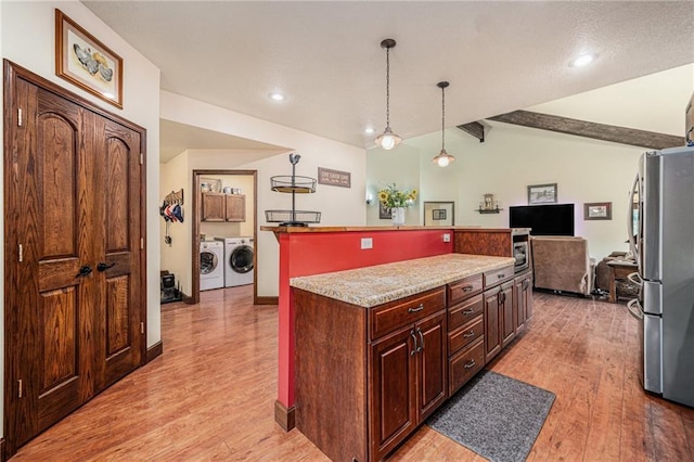 9750 SW 200th St, Smithville, MO 64089 - kitchen featuring freestanding refrigerator, separate washer and dryer, light wood-type flooring, a center island, and recessed lighting
