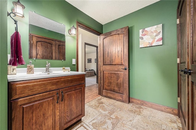 9750 SW 200th St, Smithville, MO 64089 - bathroom featuring vanity, a textured ceiling, and stone finish floors