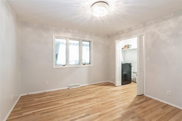 5308 Foster St, Mission, KS 66202 - unfurnished bedroom with light wood-type flooring and a chandelier