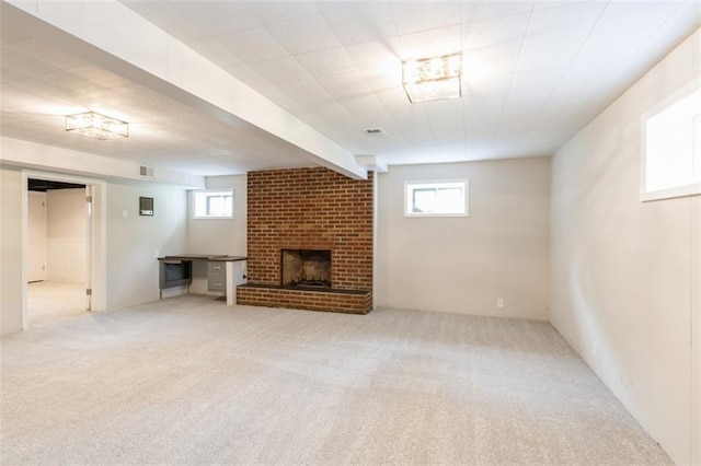 5308 Foster St, Mission, KS 66202 - unfurnished living room featuring carpet flooring, a brick fireplace, and plenty of natural light