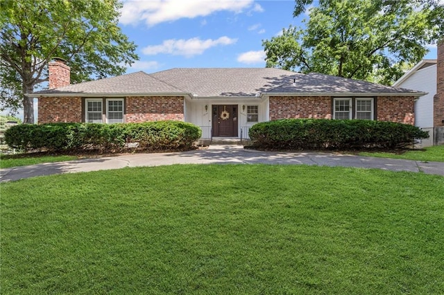 10131 W 84th St, Overland Park, KS 66212 - ranch-style house featuring a chimney, a front lawn, and brick siding