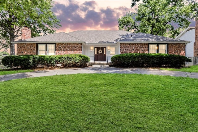 10131 W 84th St, Overland Park, KS 66212 - ranch-style house featuring a chimney, brick siding, a yard, and a shingled roof