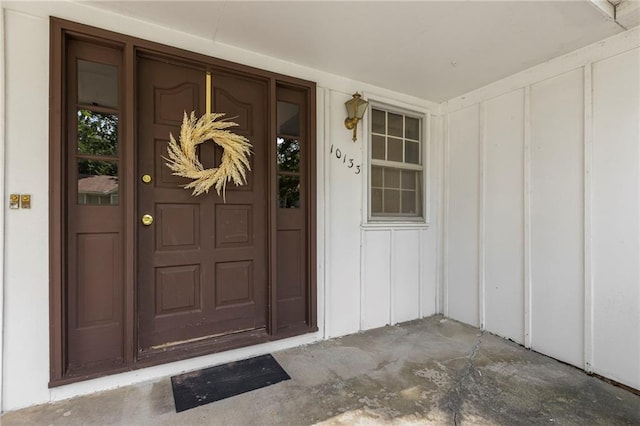 10131 W 84th St, Overland Park, KS 66212 - view of exterior entry featuring board and batten siding and covered porch