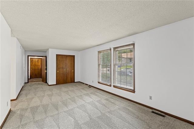 10131 W 84th St, Overland Park, KS 66212 - unfurnished bedroom featuring carpet, a textured ceiling, and a closet
