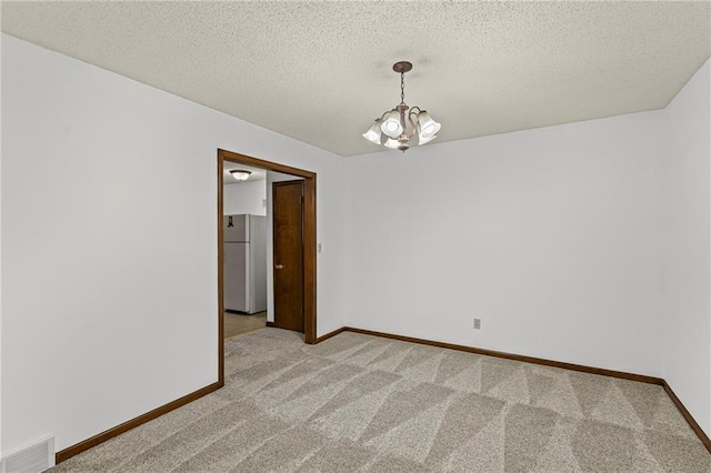 10131 W 84th St, Overland Park, KS 66212 - empty room with light colored carpet, a chandelier, and a textured ceiling