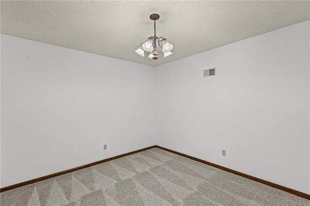 10131 W 84th St, Overland Park, KS 66212 - spare room featuring a chandelier, light colored carpet, and a textured ceiling