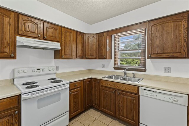 10131 W 84th St, Overland Park, KS 66212 - kitchen featuring white appliances, under cabinet range hood, a textured ceiling, light countertops, and light tile patterned floors