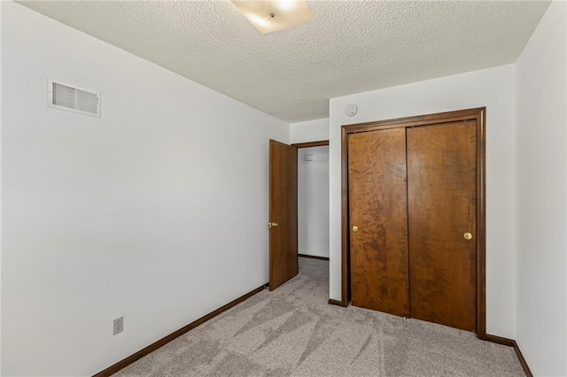 10131 W 84th St, Overland Park, KS 66212 - unfurnished bedroom with light colored carpet, a closet, and a textured ceiling