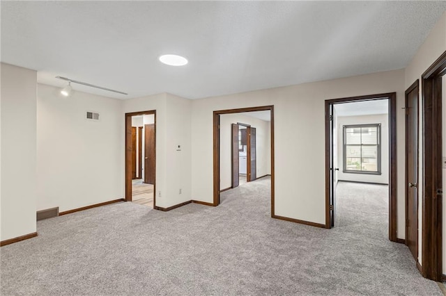 10131 W 84th St, Overland Park, KS 66212 - spare room featuring light carpet and rail lighting