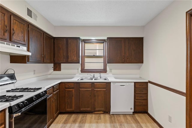 10131 W 84th St, Overland Park, KS 66212 - kitchen with dishwasher, range with gas stovetop, under cabinet range hood, light wood-style floors, and light countertops