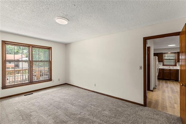 10131 W 84th St, Overland Park, KS 66212 - unfurnished room featuring light carpet and a textured ceiling