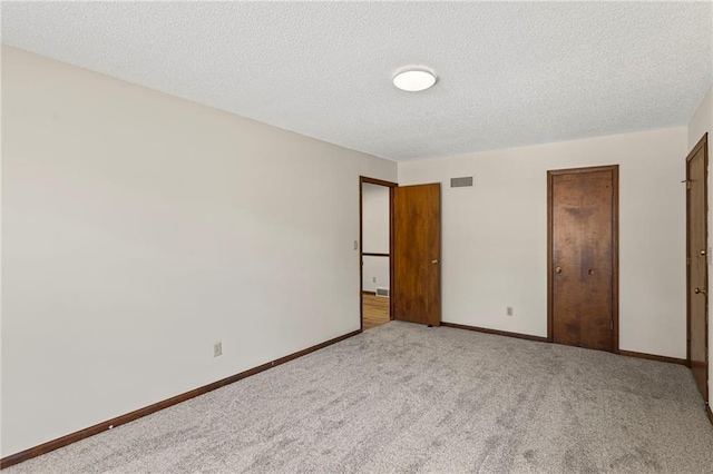 10131 W 84th St, Overland Park, KS 66212 - unfurnished bedroom with carpet floors, a textured ceiling, and a closet