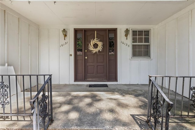 10131 W 84th St, Overland Park, KS 66212 - view of exterior entry featuring board and batten siding and a porch