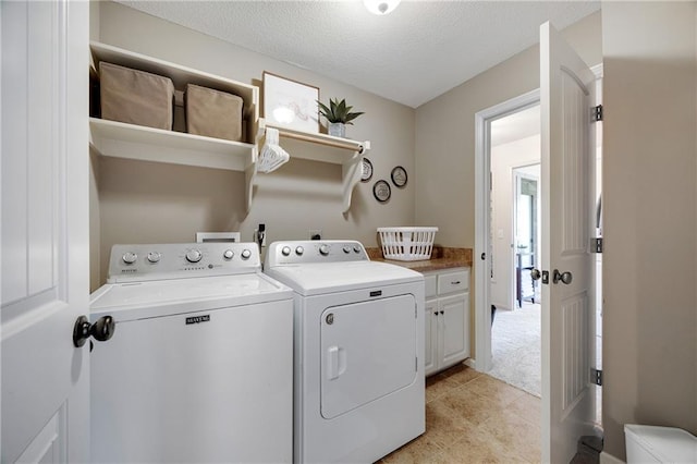 204 SW Ansel Adams Dr, Lees Summit, MO 64081 - washroom with washer and clothes dryer, cabinet space, and a textured ceiling