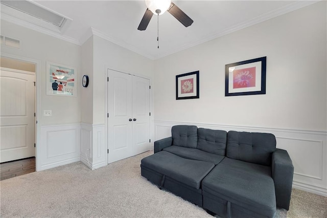 204 SW Ansel Adams Dr, Lees Summit, MO 64081 - living room with ceiling fan, crown molding, carpet, a decorative wall, and a wainscoted wall