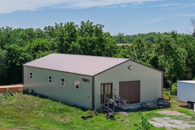 24305 Loring Rd, Lawrence, KS 66044 - back of house featuring entry steps, a metal roof, and a forest view