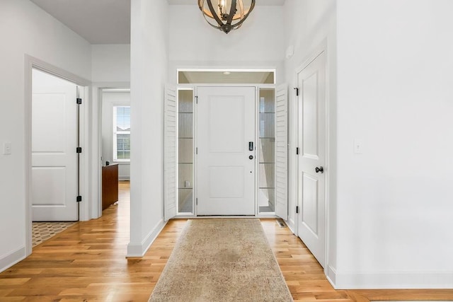 8319 Pickering St, Lenexa, KS 66227 - entryway with a chandelier and light wood-style flooring