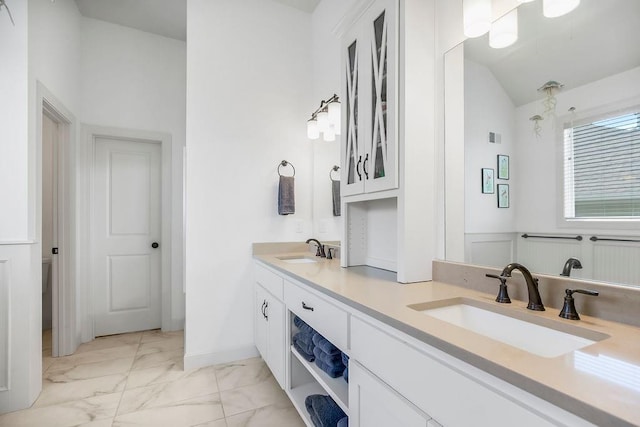 8319 Pickering St, Lenexa, KS 66227 - bathroom featuring marble finish flooring, double vanity, and vaulted ceiling