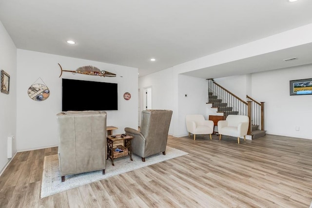 8319 Pickering St, Lenexa, KS 66227 - living room with light wood finished floors, stairway, and recessed lighting